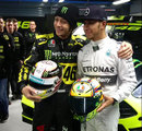 Moto GP legend Valentino Rossi and 2014 F1 world champion Lewis Hamilton exchange helmets