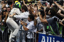 Felipe Massa celebrates second by leaping into the arms of his mechanics in parc ferme