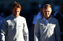 Jenson Button and Kevin Magnussen walk together in the paddock