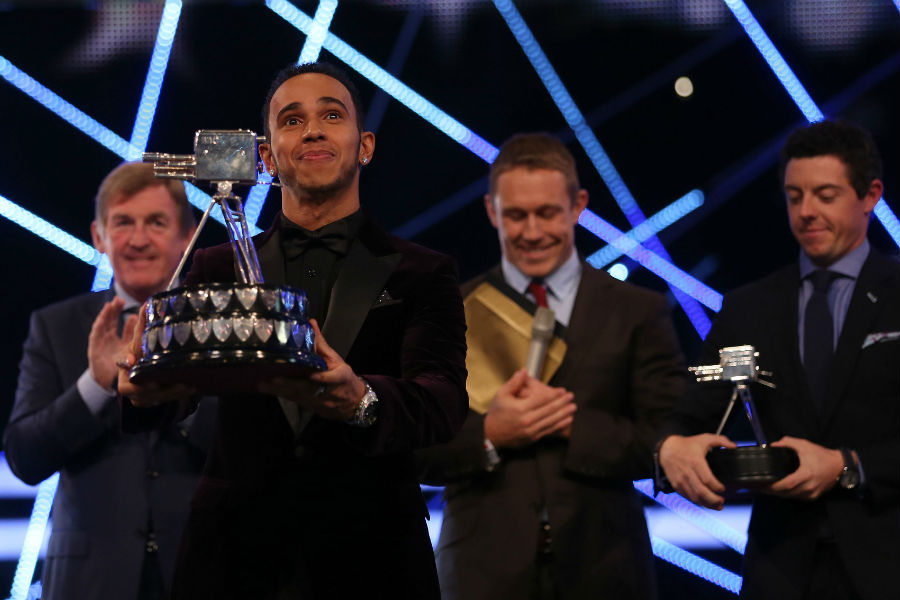 Lewis Hamilton celebrates with the Sports Personality of the Year trophy