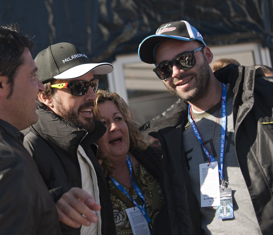 Fernando Alonso poses with Spanish supporters during the first day of testing