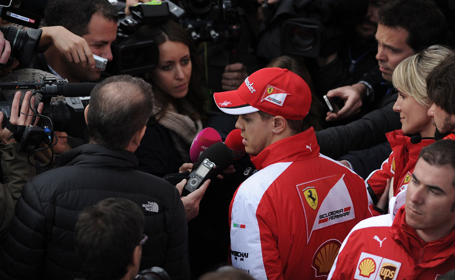 Sebastian Vettel talks to the media after his session