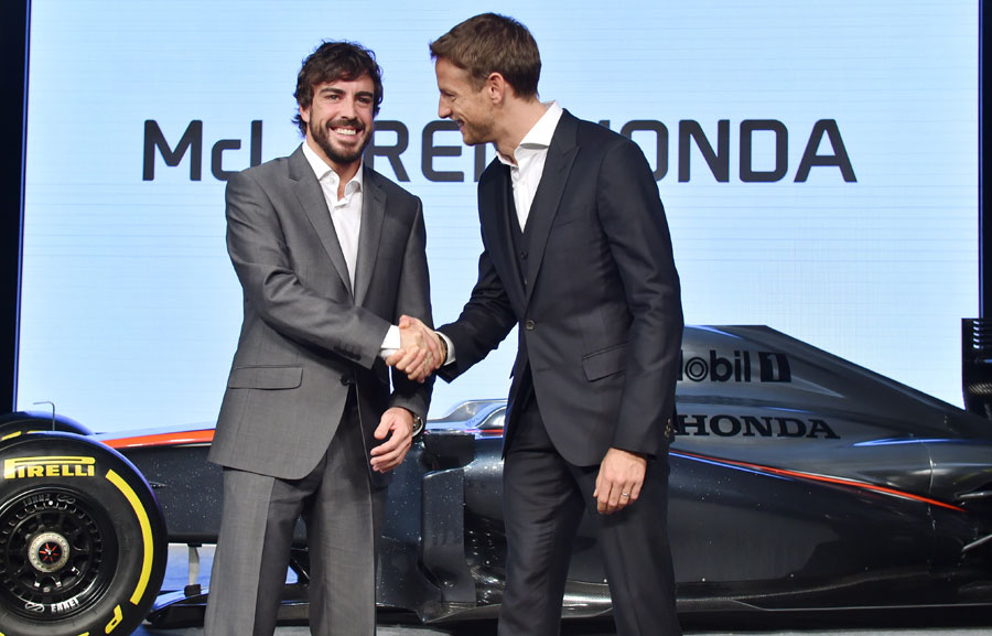 McLaren team-mates Fernando Alonso and Jenson Button shake hands at a Honda press conference