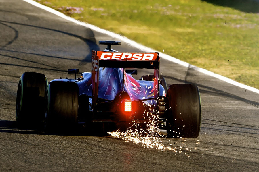 Sparks fly from the Toro Rosso of Max Verstappen