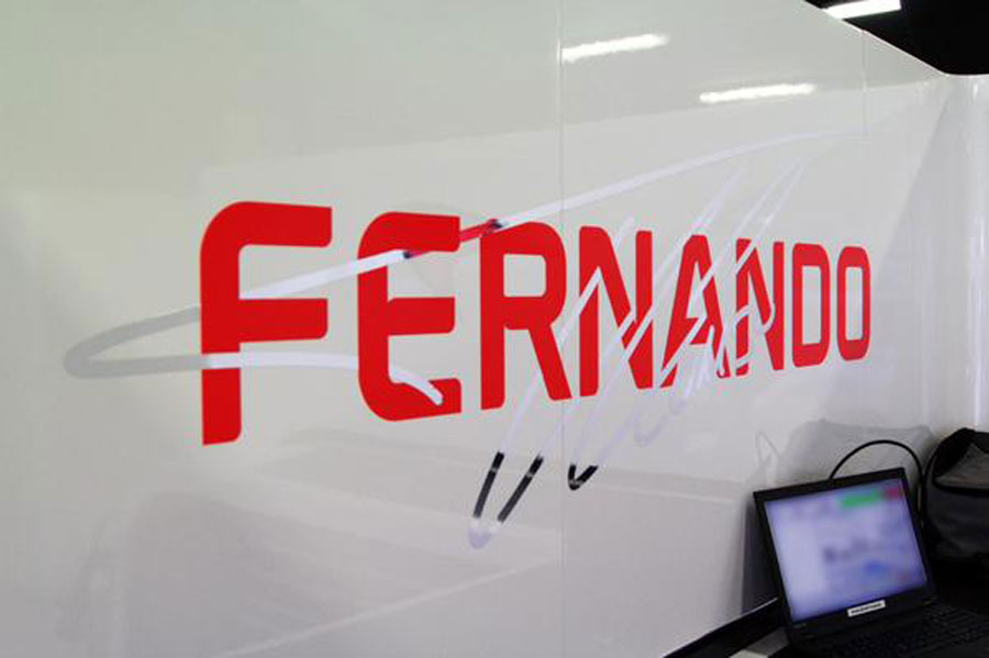 Fernando Alonso's new sign is painted on the McLaren garage wall during a filming day in Barcelona