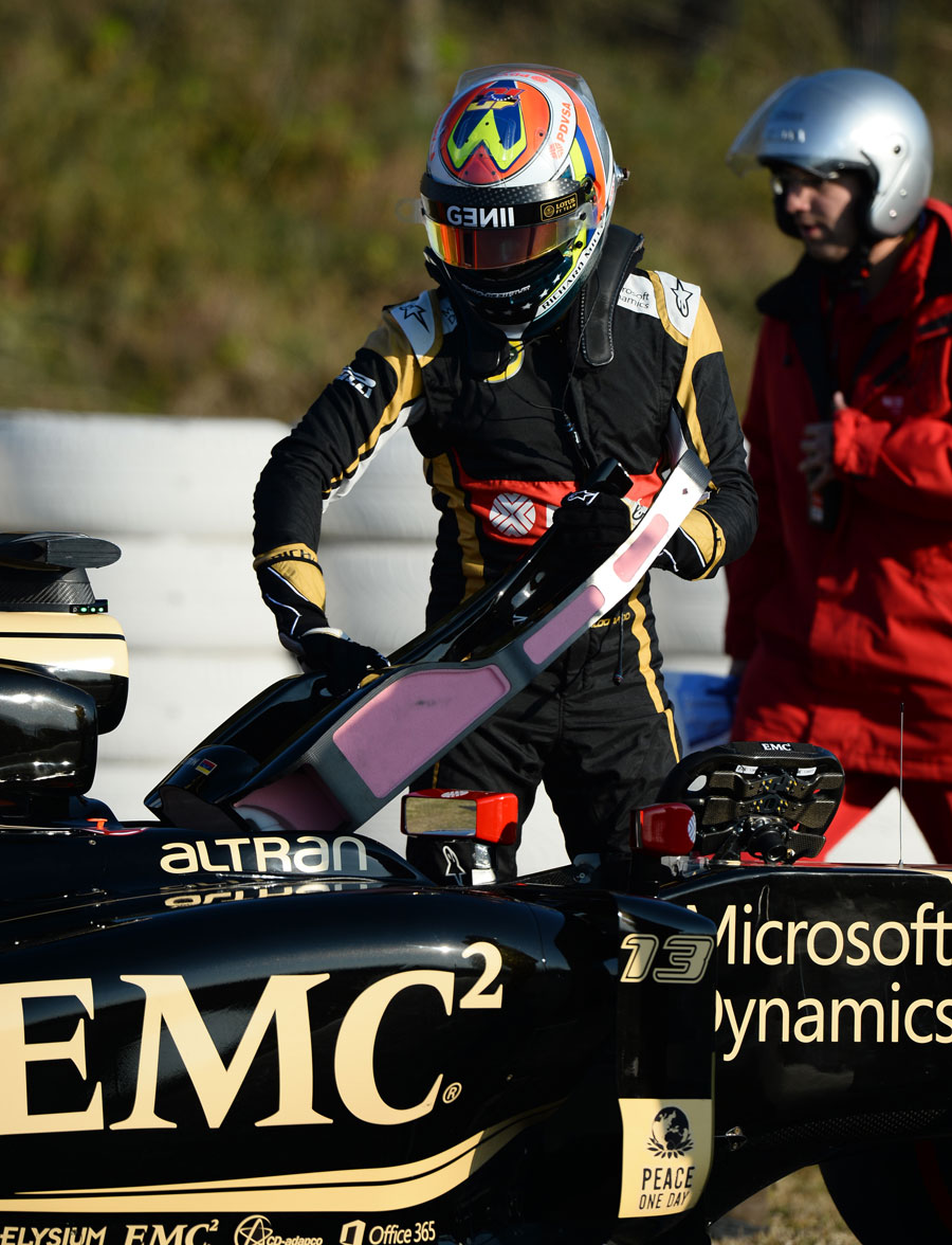 Pastor Maldonado steps out of his Lotus after stopping on Thursday morning