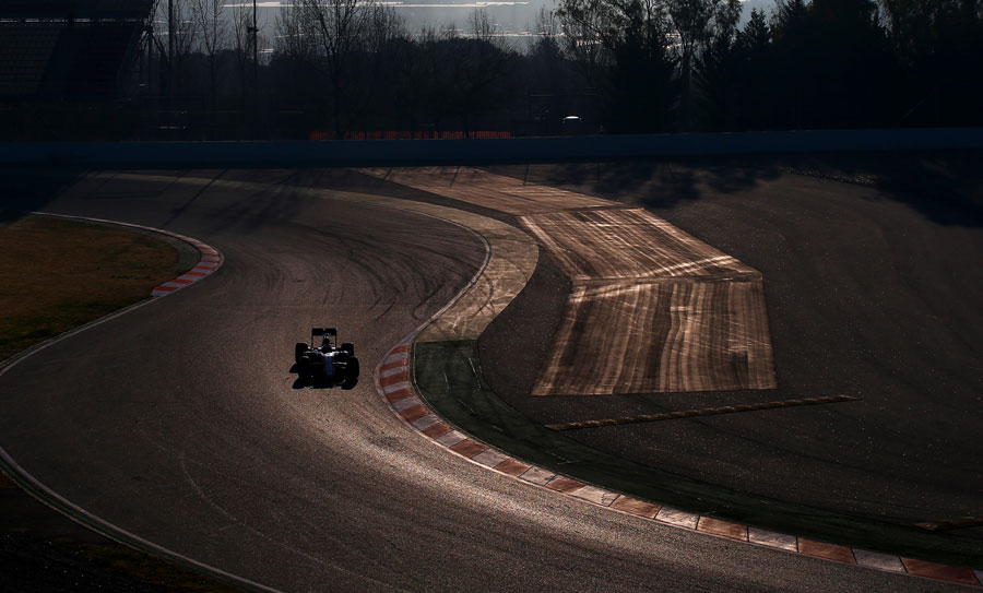 Jenson Button navigates the McLaren through the first chicane