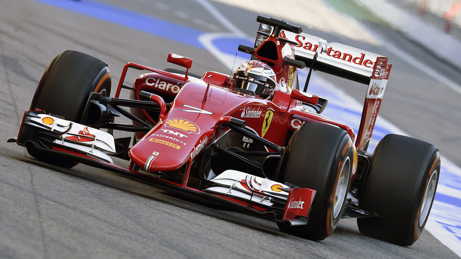 Ferrari's Kimi Raikkonen drives down the pit lane 
