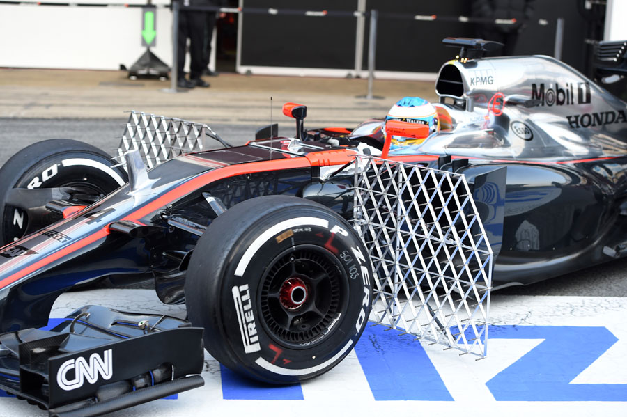Fernando Alonso leaves the garage in the morning with aero sensors on his McLaren