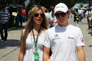 Nico Rosberg walks through the paddock with his girlfriend