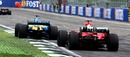 Fernando Alonso crosses the finish line ahead of Michael Schumacher