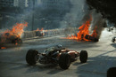 Chris Amon passes the horrifying crash of his team-mate Lorenzo Bandini