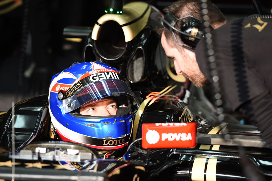 Lotus reserve driver Jolyon Palmer talks to an engineer from the cockpit