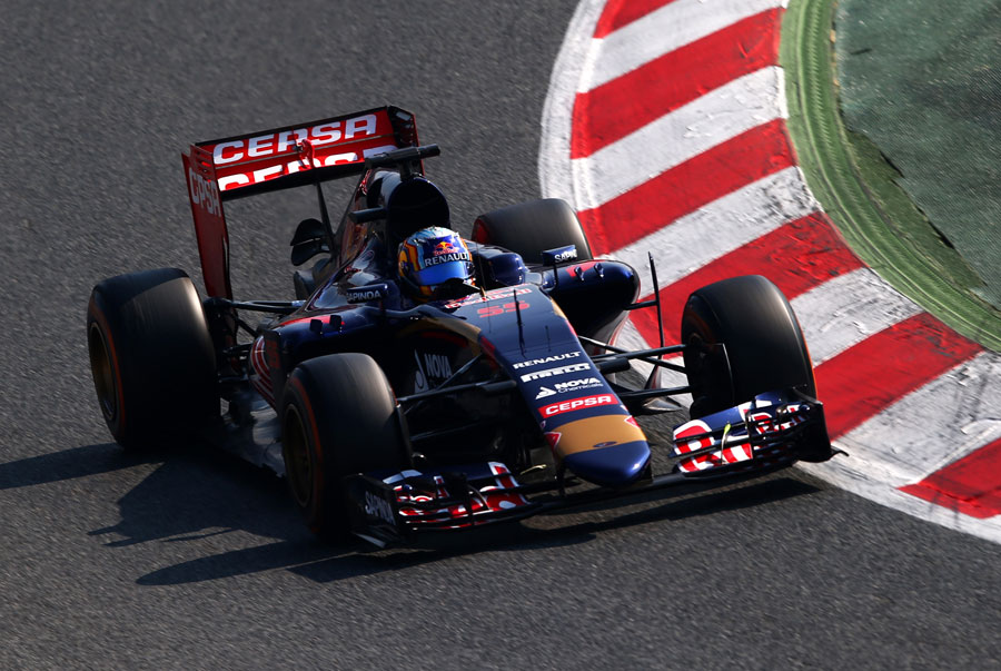 Carlos Sainz Jr glances his Toro Rosso along the kerb