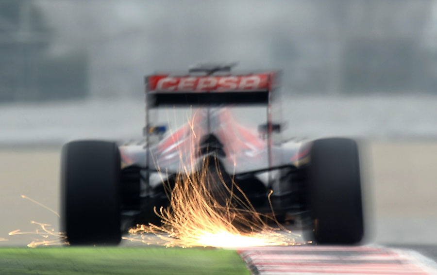 Sparks fly from the back of Max Verstappen's Toro Rosso on Saturday morning