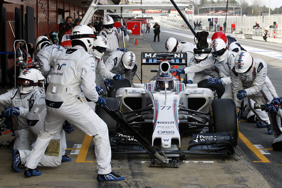 Williams mechanics practice a pit stop on Valtteri Bottas' car