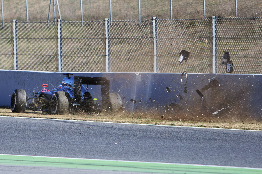 Fernando Alonso hits the barriers in his McLaren