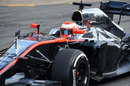 Jenson Button drives through the pit lane in the McLaren MP4-30