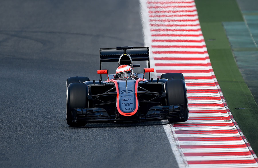 Jenson Button rides the kerb in the McLaren MP4-30