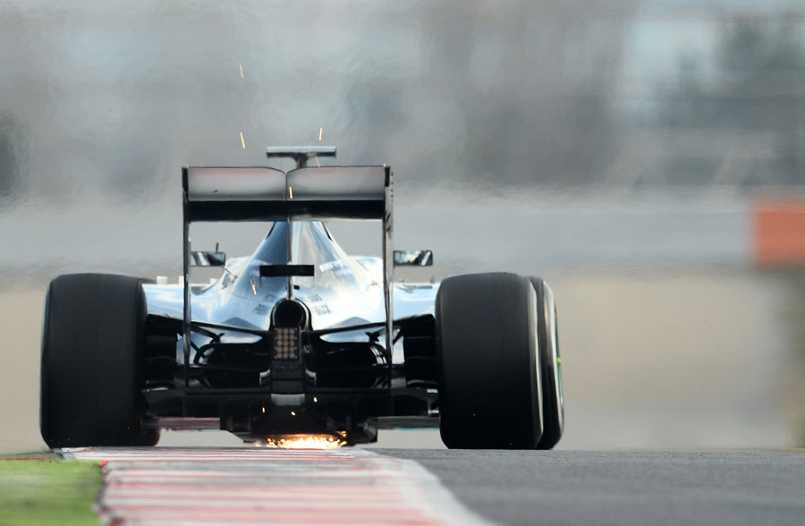Sparks fly from the rear of Nico Rosberg's Mercedes
