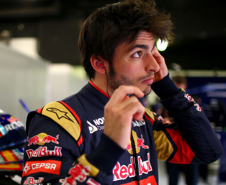 Carlos Sainz looks on in the Toro Rosso garage