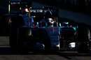 Lewis Hamilton's Mercedes leads Nico Hulkenberg through the pit lane