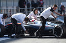 McLaren mechanics wheel Kevin Magnussen back into the garage