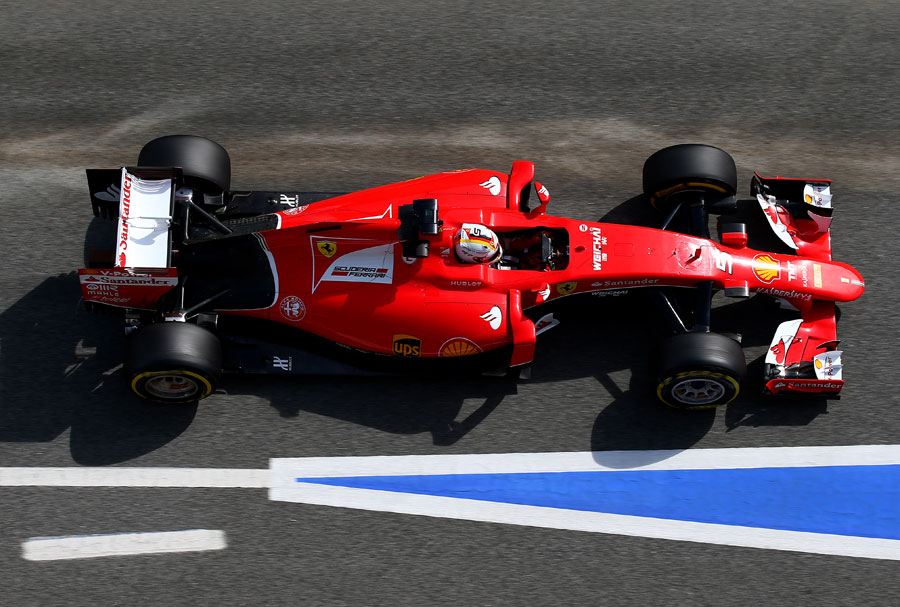 Sebastian Vettel drives his Ferrari through the pits