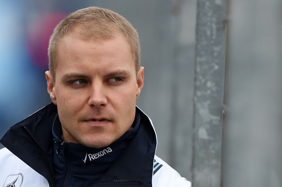 Valtteri Bottas watches on from the pit wall