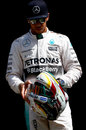 Lewis Hamilton looks down at his 2015 helmet at the traditional pre-season driver photoshoot in Melbourne