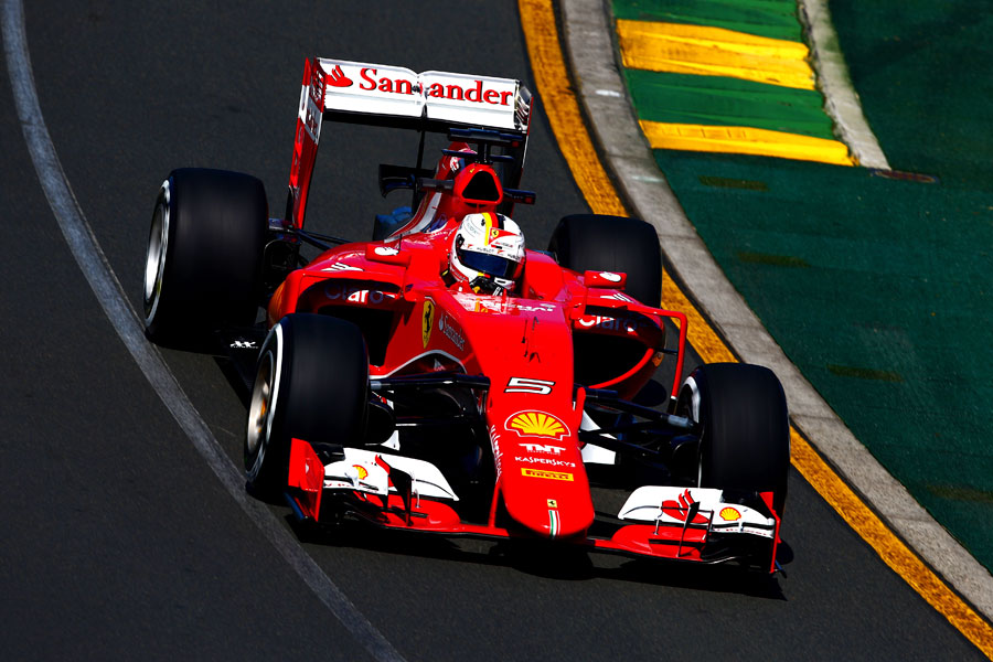 Sebastian Vettel guides his Ferrari through the first corner