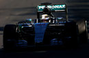 Lewis Hamilton drives through the shade with his Mercedes