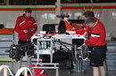 Mechanics work on the Manor F1 car
