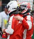Kimi Raikkonen greets Ferrari team-mate Sebastian Vettel after qualifying