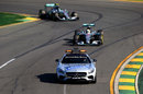 The safety car leads Lewis Hamilton and Nico Rosberg