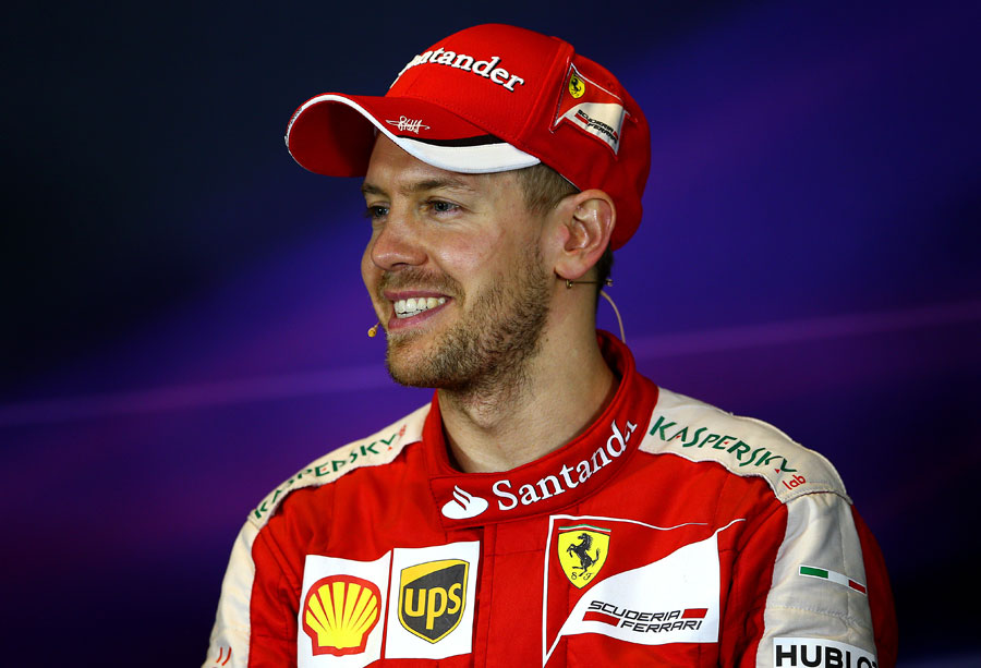 Sebastian Vettel is all smiles in the post-race press conference