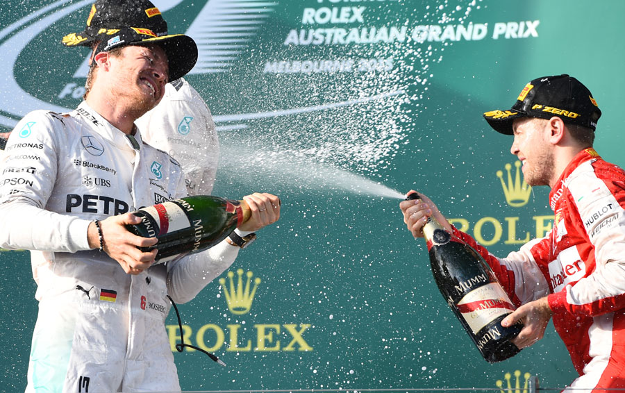 Nico Rosberg and Sebastian Vettel celebrate second and third on the podium