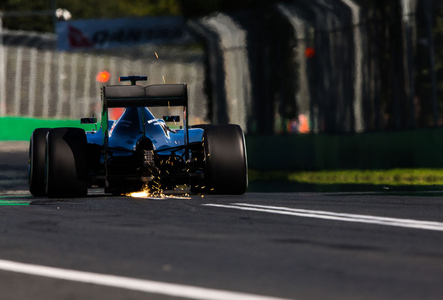 Sparks fly from the rear of Lewis Hamilton's Mercedes