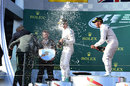 Race-winner Lewis Hamilton sprays Sir Jackie Stewart from the top step of the podium