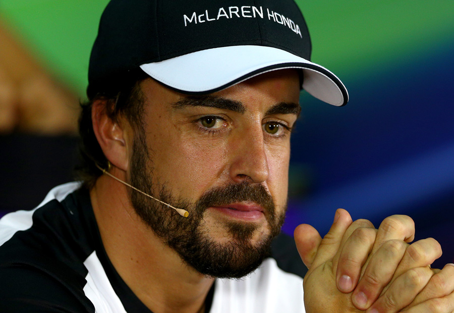 Fernando Alonso looks on in the FIA press conference