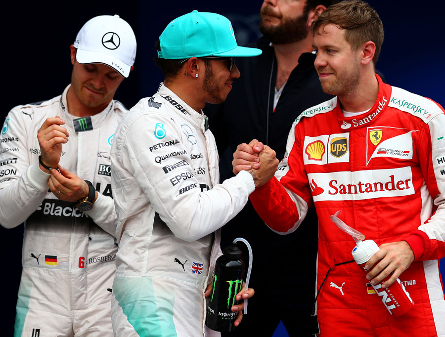Sebastian Vettel congratulates Lewis Hamilton on taking pole