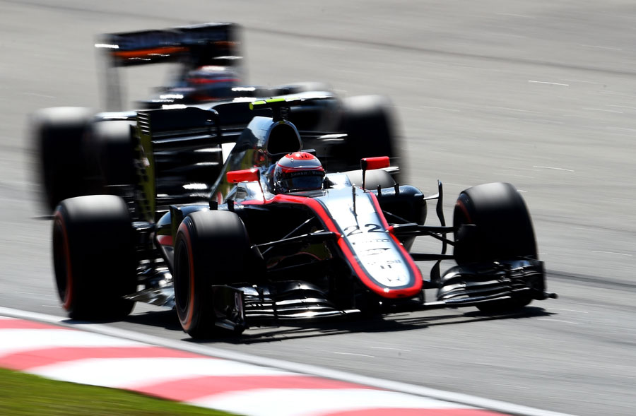 Jenson Button leads a Force India on track