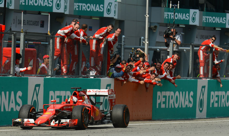 Sebastian Vettel and Ferrari celebrates as the German takes the chequered flag