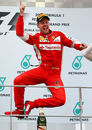Sebastian Vettel leaps for joy on the top step of the podium