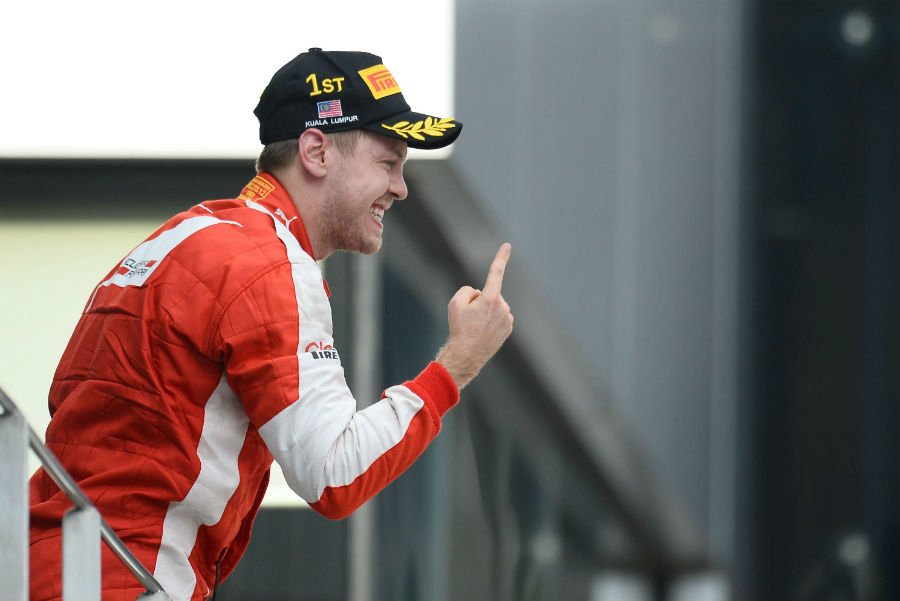 Sebastian Vettel waves the finger after his maiden Ferrari victory