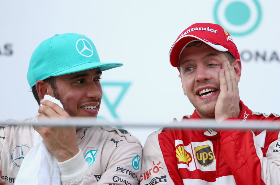 Lewis Hamilton sits with race-winner Sebastian Vettel on the podium