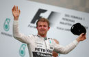 Nico Rosberg salutes the crowd from the podium after finishing third