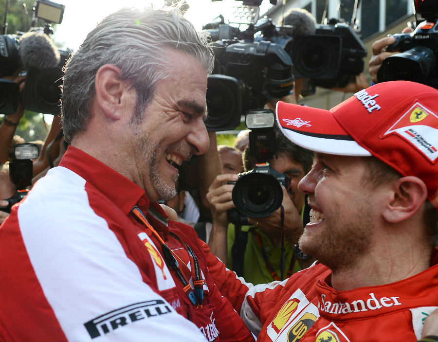 Ferrari boss Maurizio Arrivabene embraces race-winner Sebastian Vettel