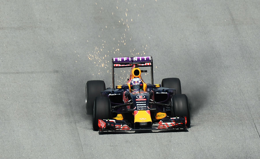 Brake dust and sparks fly from Daniel Ricciardo's Red Bull