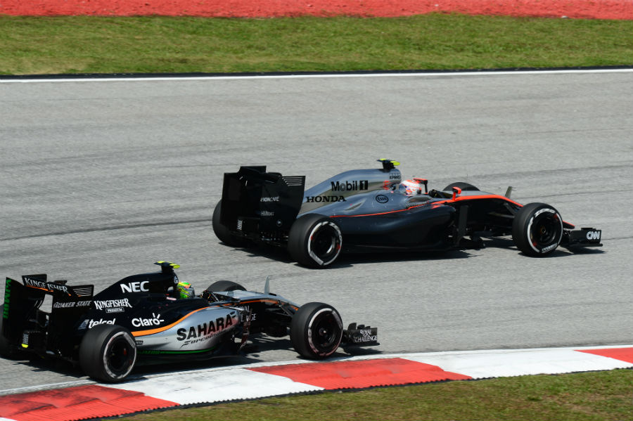 Jenson Button leads Force India's Sergio Perez through a corner